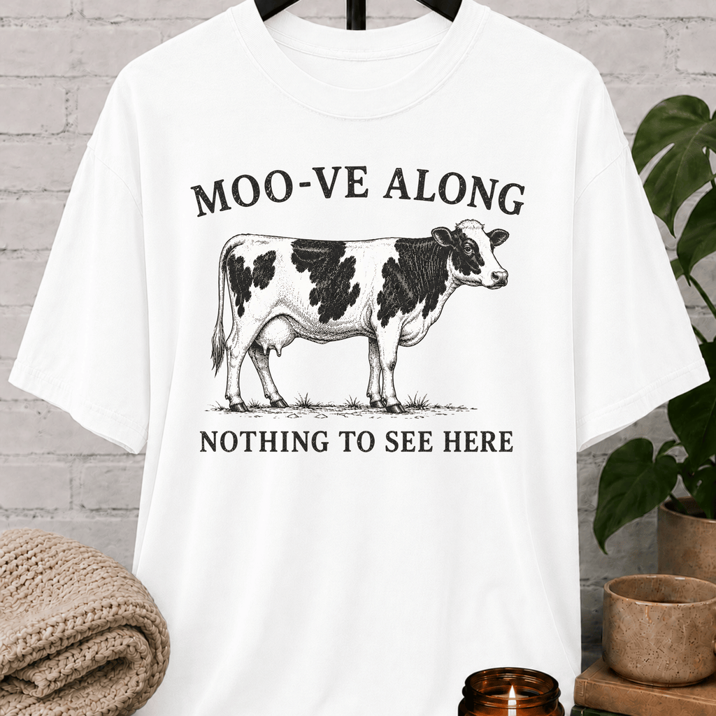 Funny cow graphic T-shirt featuring the phrase "Moo-ve Along Nothing to See Here," a sarcastic introvert shirt, funny farm animal shirt, and humorous graphic tee for homebodies and lovers of witty apparel.