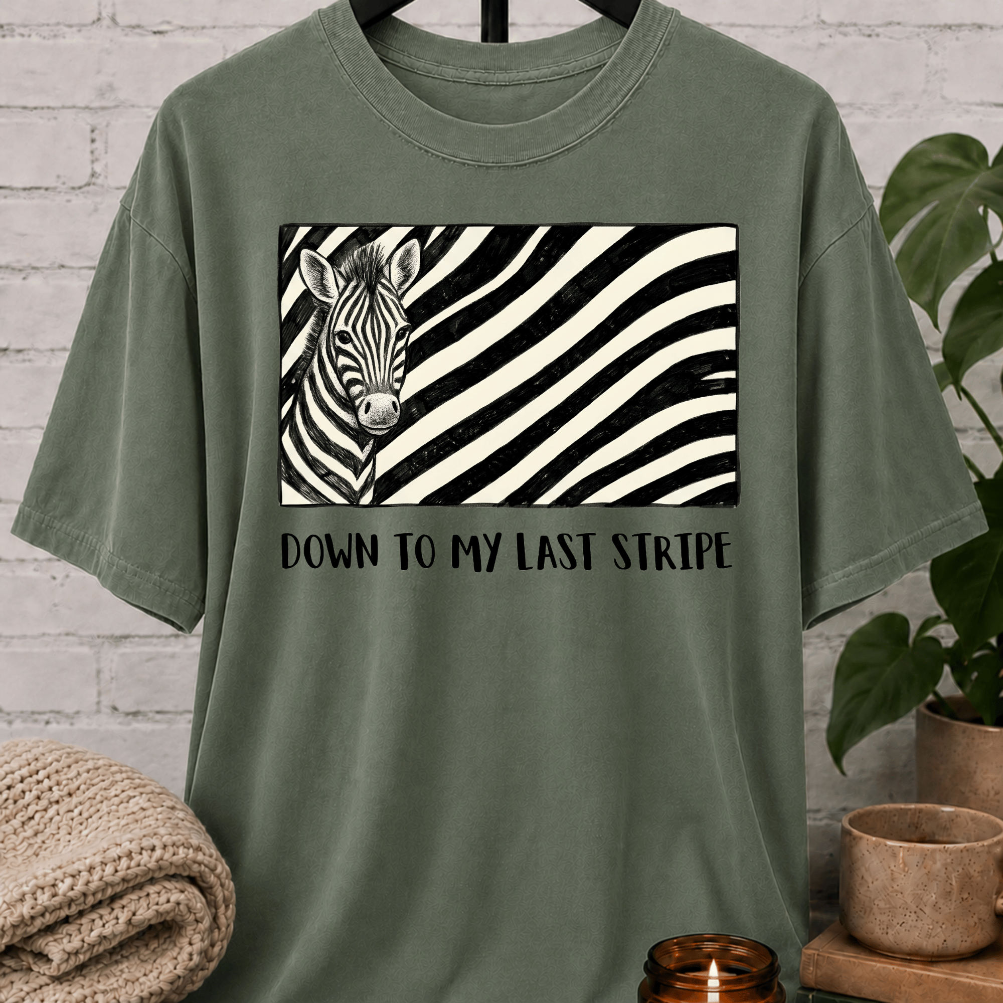 Funny zebra graphic T-shirt featuring a black and white zebra illustration with bold zebra stripes and the phrase “Down to My Last Stripe,” a sarcastic overwhelmed humor shirt for overthinkers and animal lovers.