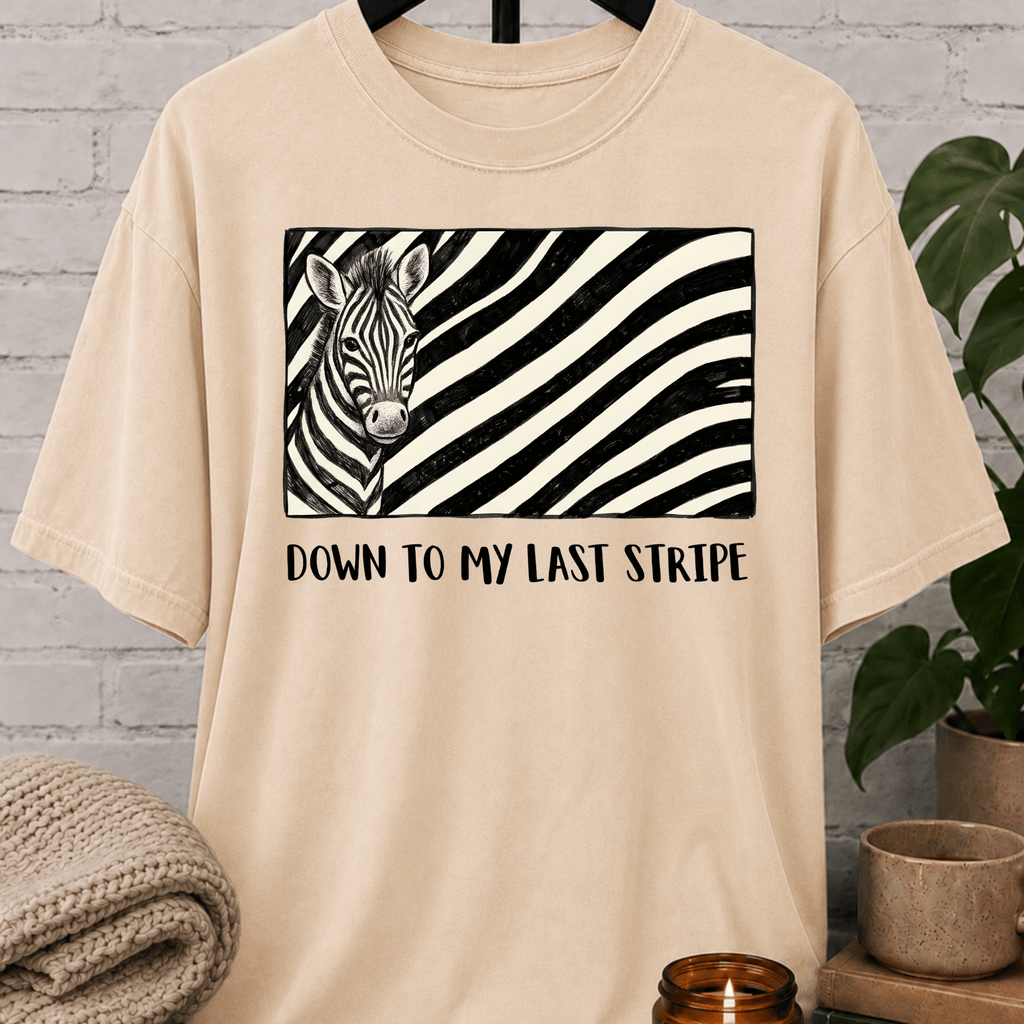 Funny zebra graphic T-shirt featuring a black and white zebra illustration with bold zebra stripes and the phrase “Down to My Last Stripe,” a sarcastic overwhelmed humor shirt for overthinkers and animal lovers.