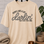 Western homebody T-shirt featuring rope-style lettering and the phrase “People Are a Lot Darlin’ That’s Why I Stay Home,” a funny sarcastic graphic tee for introverts, antisocial personalities, and stay-home lovers.
