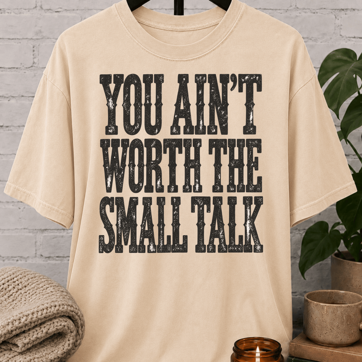 Sarcastic antisocial T-shirt featuring the phrase “You Ain’t Worth the Small Talk” in a distressed graphic design for introverts, loners, and people who hate small talk.