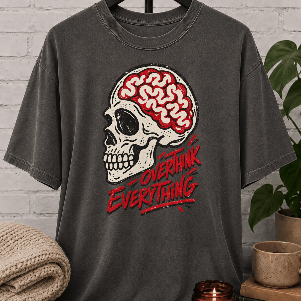 Overthink Everything skull T-shirt featuring an exposed brain illustration and bold graphic lettering, a dark humor graphic tee for overthinkers, worriers, and fans of anxious humor.