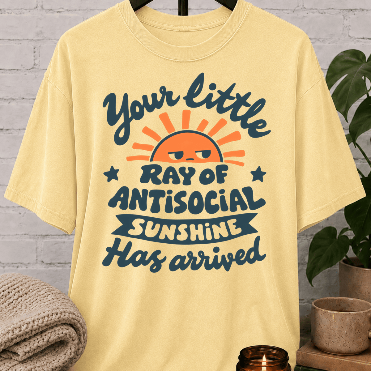 Funny antisocial T-shirt featuring an unimpressed retro sun and the phrase “Your Little Ray of Antisocial Sunshine Has Arrived,” a sarcastic graphic tee for socially selective and people-averse humor fans.