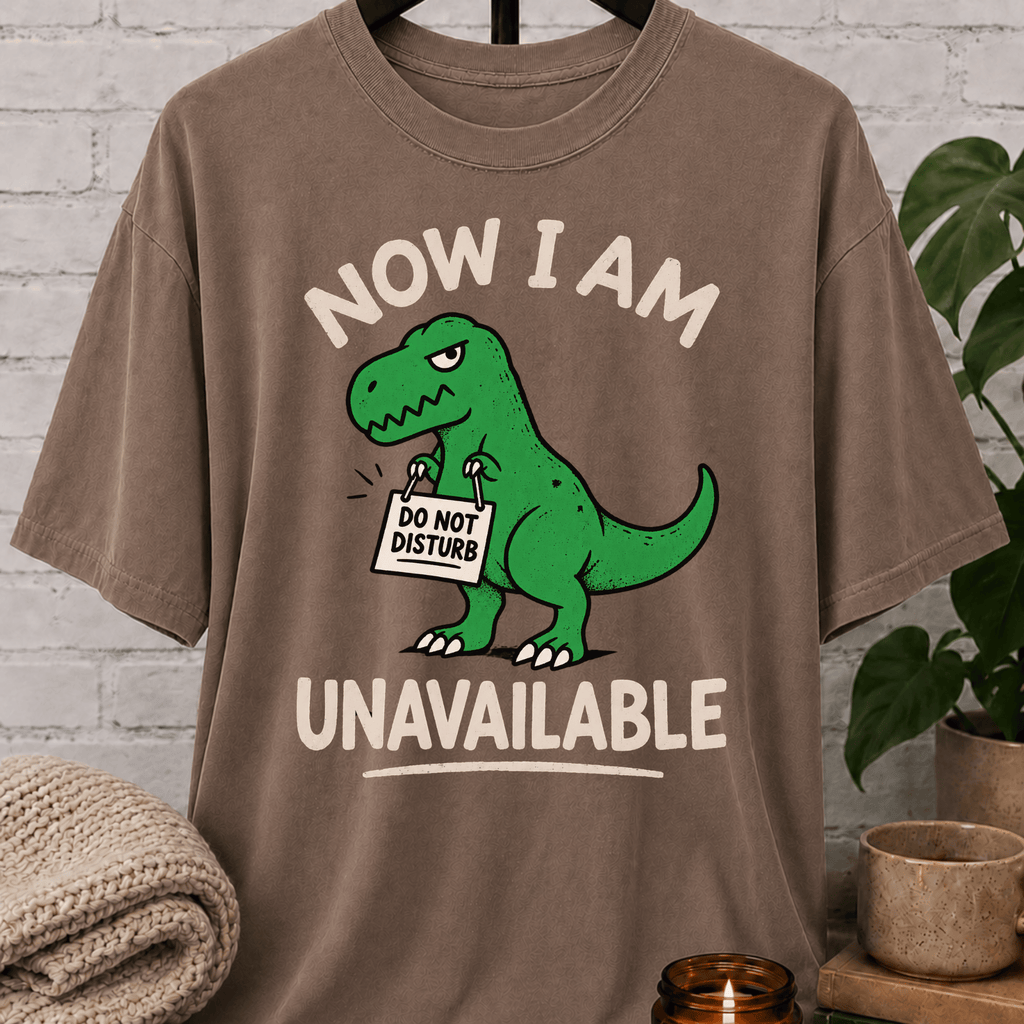 Funny dinosaur T-shirt featuring a green T-rex holding a “Do Not Disturb” sign with the phrase “Now I Am Unavailable,” a sarcastic loner graphic tee for hermits, socially unavailable types, and personal space humor fans.