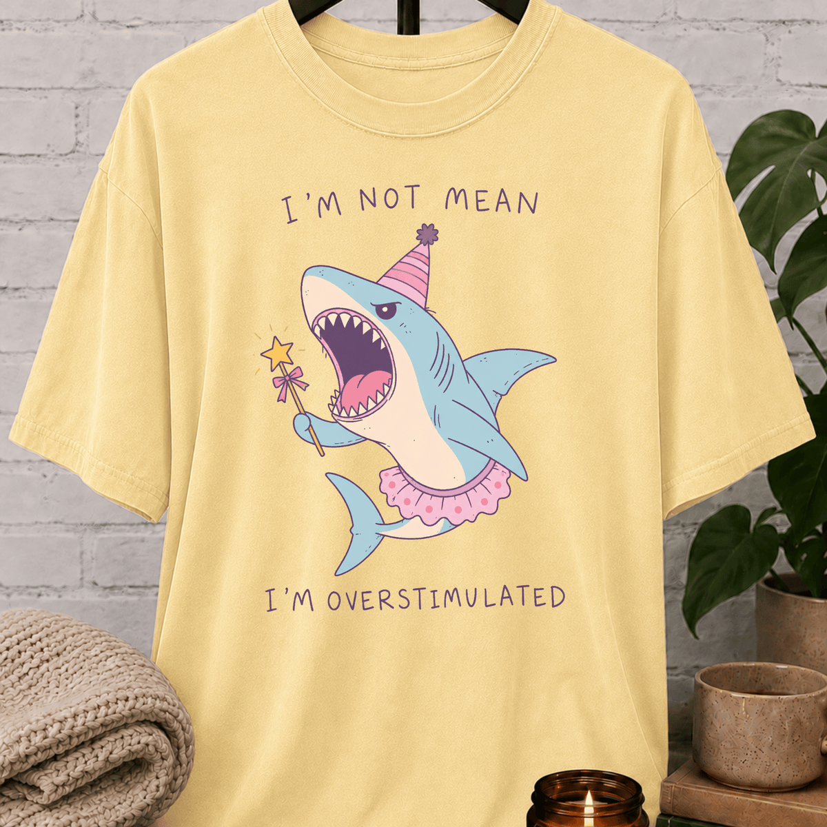 Overstimulated shark T-shirt featuring a funny cartoon shark in a party hat and tutu with the phrase “I’m Not Mean I’m Overstimulated,” a humorous graphic tee for overthinkers and easily overwhelmed people.