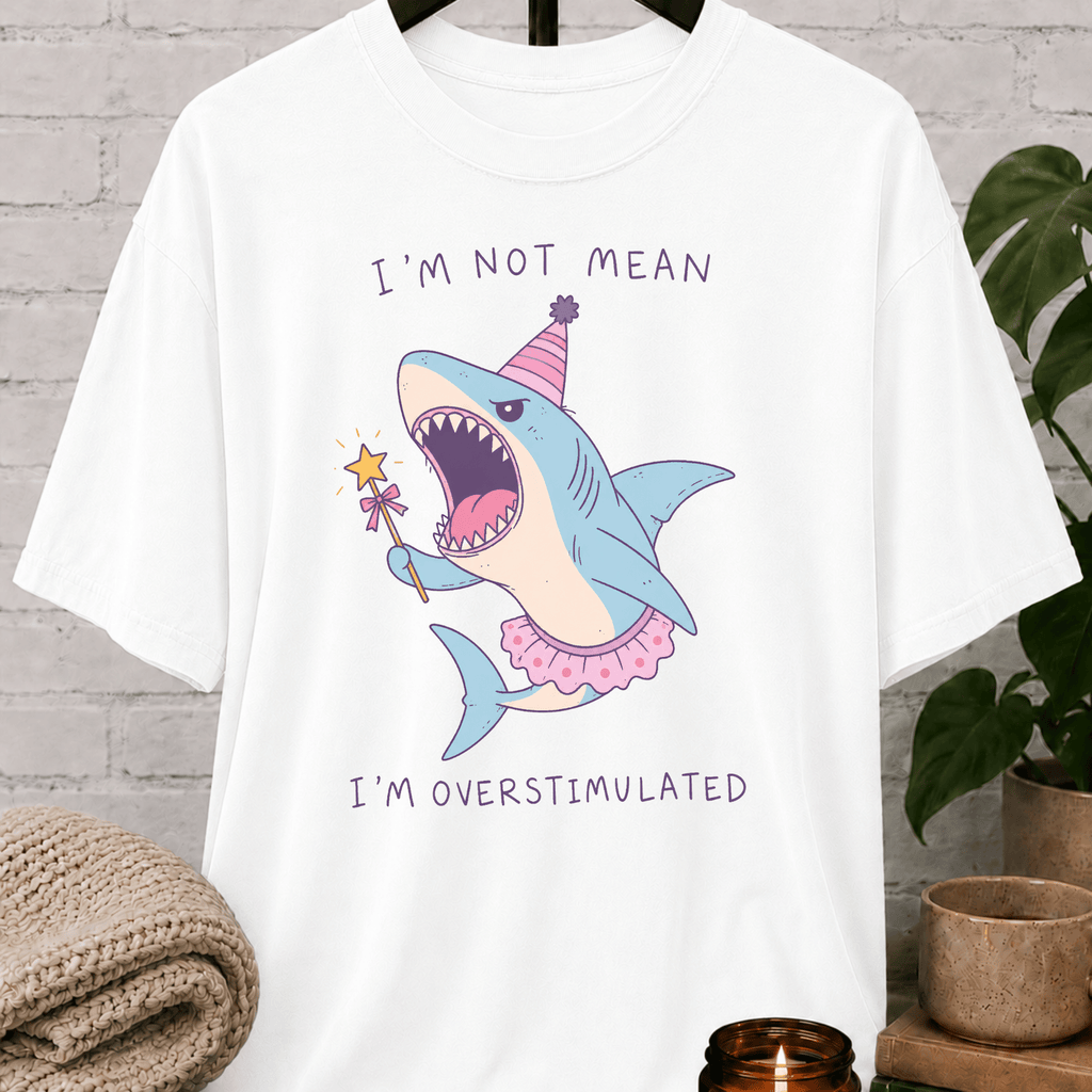 Overstimulated shark T-shirt featuring a funny cartoon shark in a party hat and tutu with the phrase “I’m Not Mean I’m Overstimulated,” a humorous graphic tee for overthinkers and easily overwhelmed people.