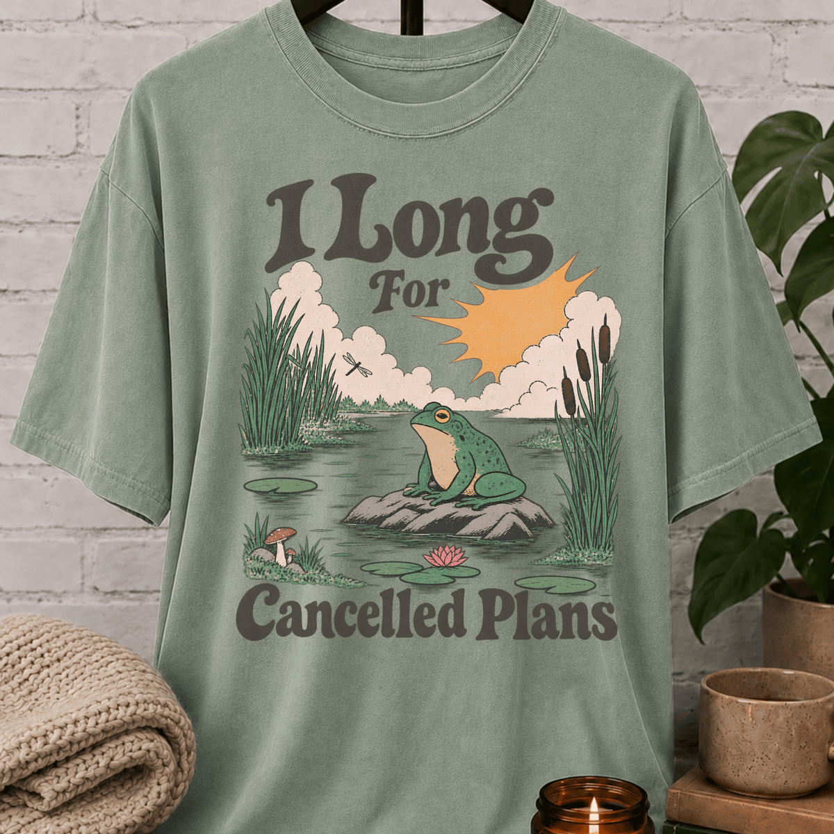 Funny cancelled plans frog T-shirt featuring a vintage pond scene with a frog and the phrase “I Long For Cancelled Plans,” a socially selective graphic tee for chronic cancellers and solitude lovers.