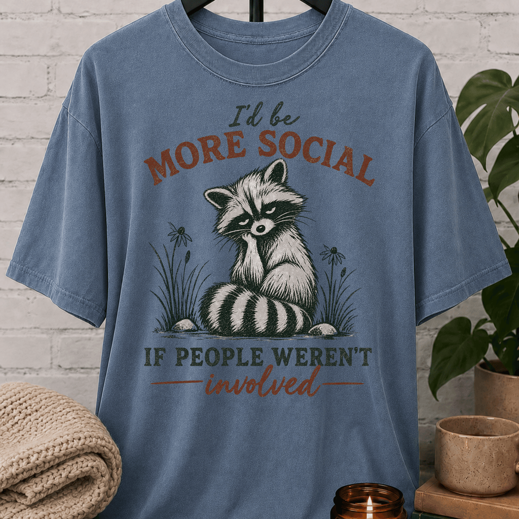 Funny raccoon graphic T-shirt featuring a vintage raccoon and the phrase “I’d Be More Social If People Weren’t Involved,” a sarcastic antisocial shirt for socially selective people and fans of avoid-people humor.