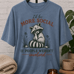 Funny raccoon graphic T-shirt featuring a vintage raccoon and the phrase “I’d Be More Social If People Weren’t Involved,” a sarcastic antisocial shirt for socially selective people and fans of avoid-people humor.