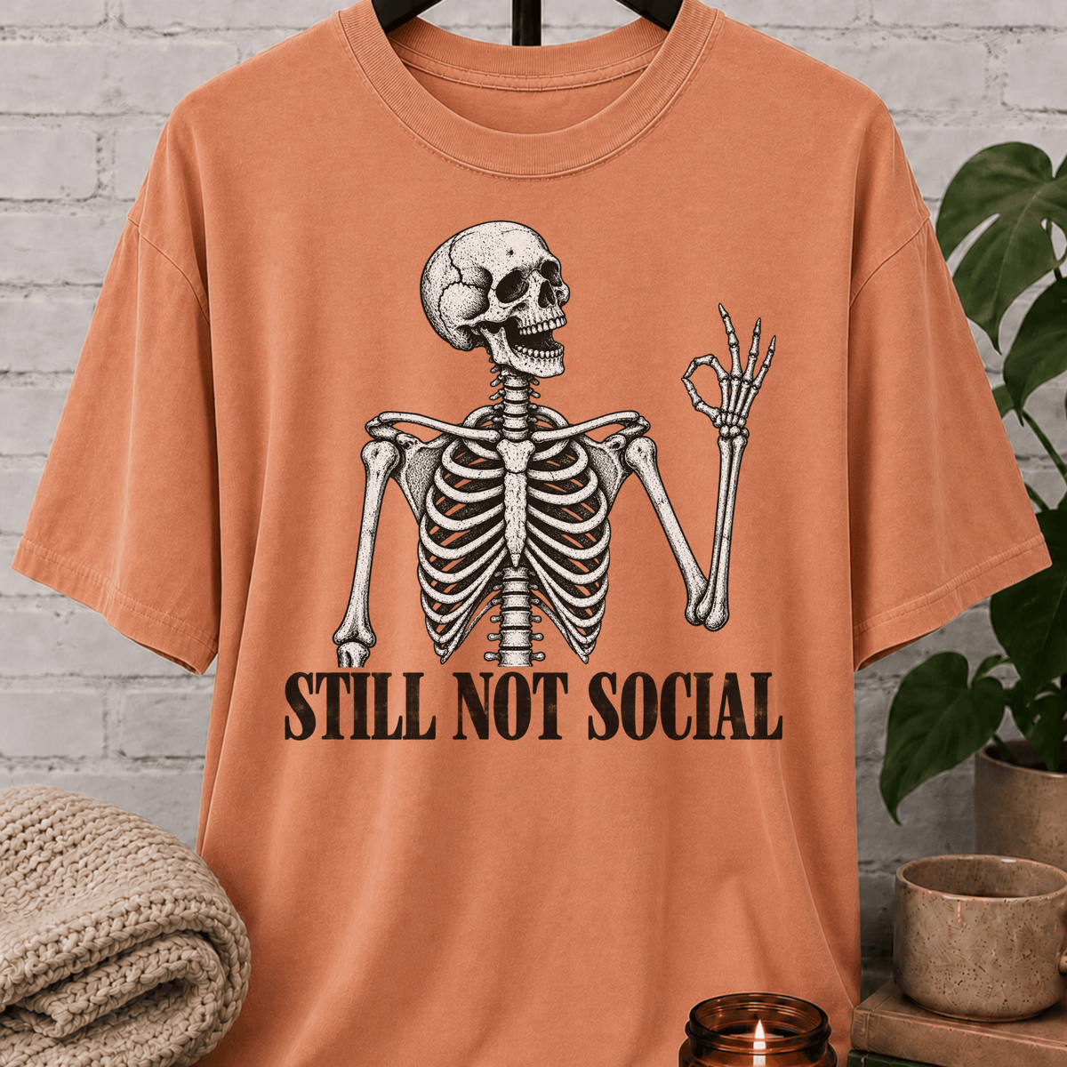 Funny skeleton T-shirt featuring a vintage skeleton graphic with the phrase “Still Not Social,” a low social battery shirt for loners, people-avoiders, and fans of sarcastic social humor.