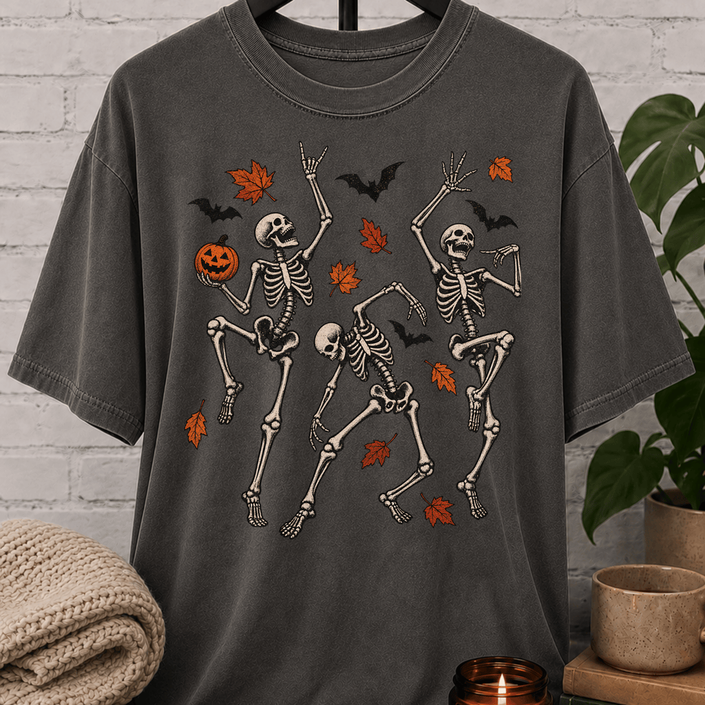 Fall Halloween skeleton T-shirt featuring three dancing skeletons, autumn leaves, bats, and a jack-o’-lantern, a spooky graphic tee for introverts and Halloween lovers.