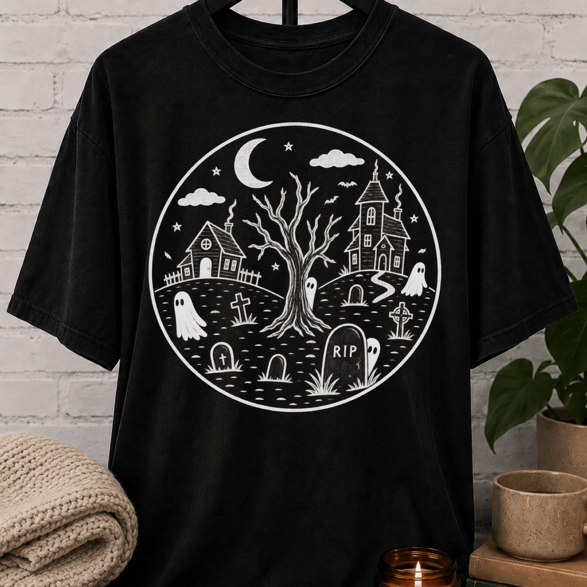 Antisocial Halloween ghost graveyard T-shirt featuring a spooky black and white haunted village scene with ghosts, tombstones, a crescent moon, bare tree, and eerie houses, a graphic tee for antisocial humor and Halloween lovers.