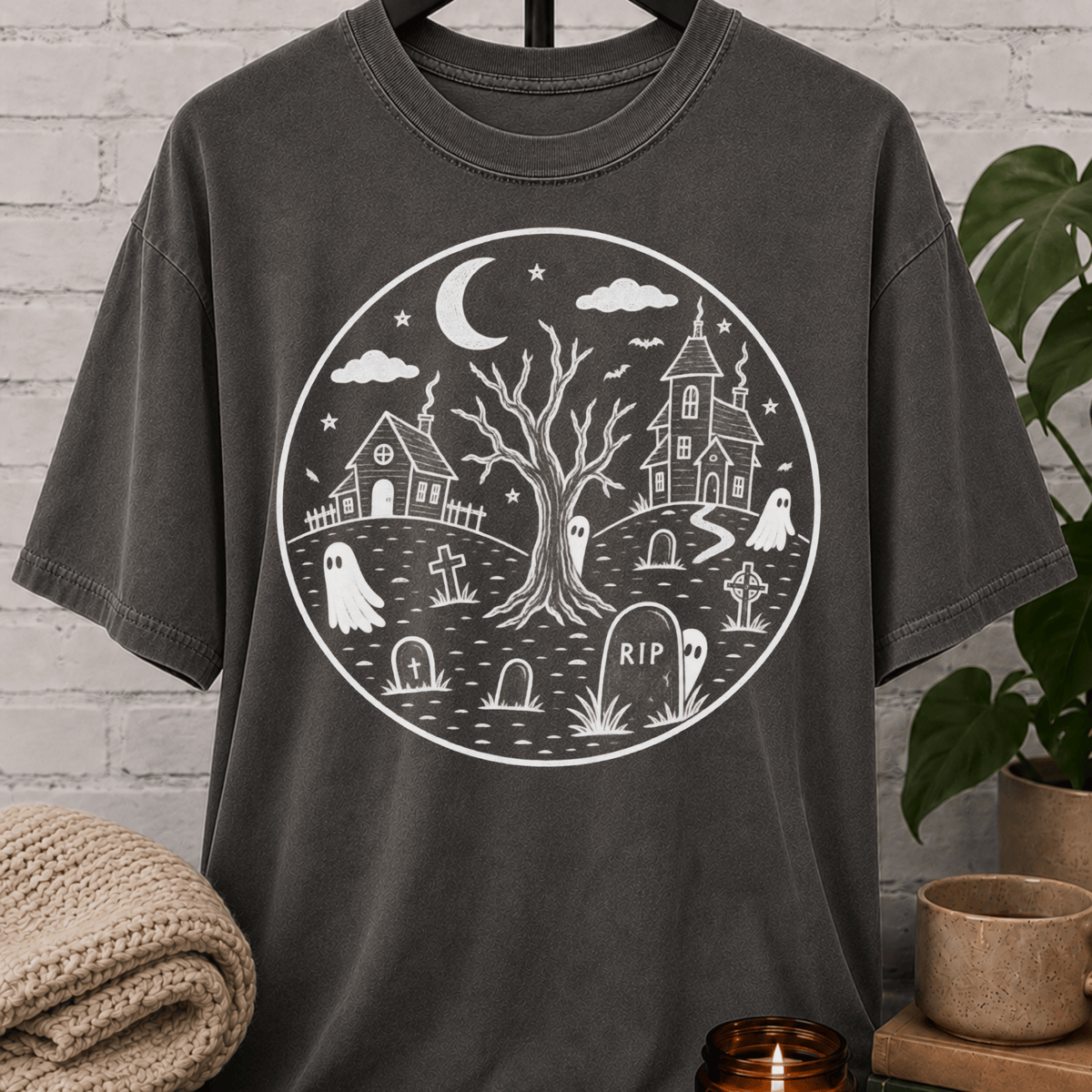 Antisocial Halloween ghost graveyard T-shirt featuring a spooky black and white haunted village scene with ghosts, tombstones, a crescent moon, bare tree, and eerie houses, a graphic tee for antisocial humor and Halloween lovers.
