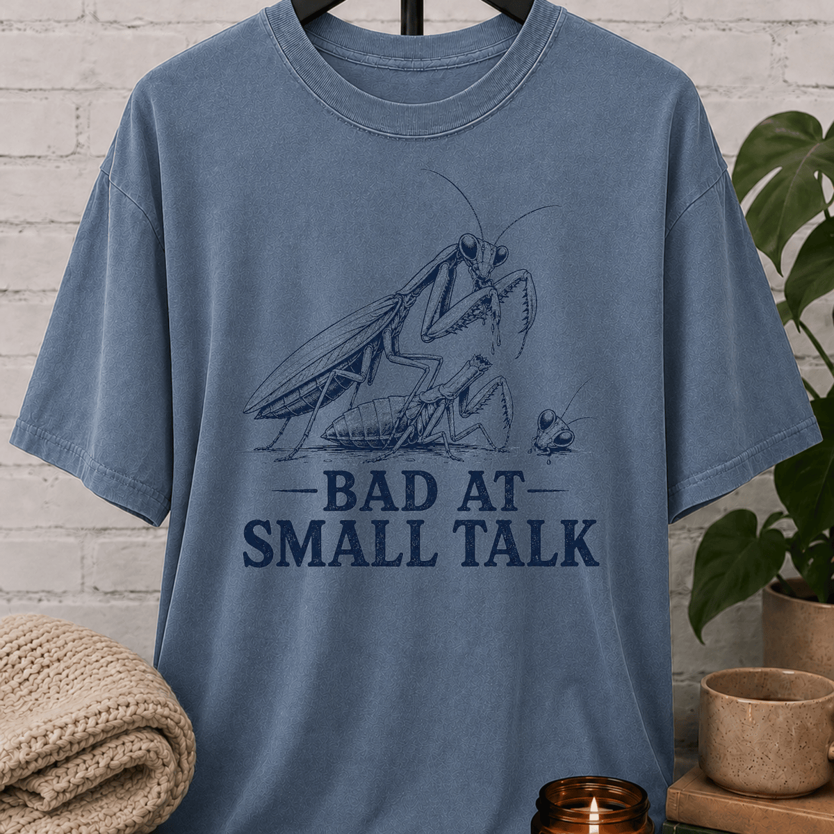 Socially awkward praying mantis T-shirt featuring two illustrated insects and the phrase “Bad at Small Talk,” a sarcastic graphic tee for awkward humor fans, quiet types, and people who hate forced conversation.