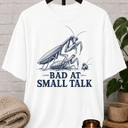Socially awkward praying mantis T-shirt featuring two illustrated insects and the phrase “Bad at Small Talk,” a sarcastic graphic tee for awkward humor fans, quiet types, and people who hate forced conversation.