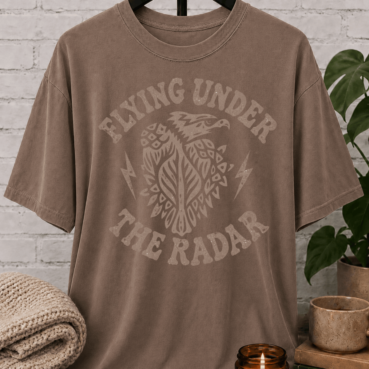 Loner eagle graphic T-shirt featuring a vintage flying eagle, lightning bolt accents, and the phrase “Flying Under the Radar,” a low-profile shirt for private people and fans of sarcastic solitude humor.