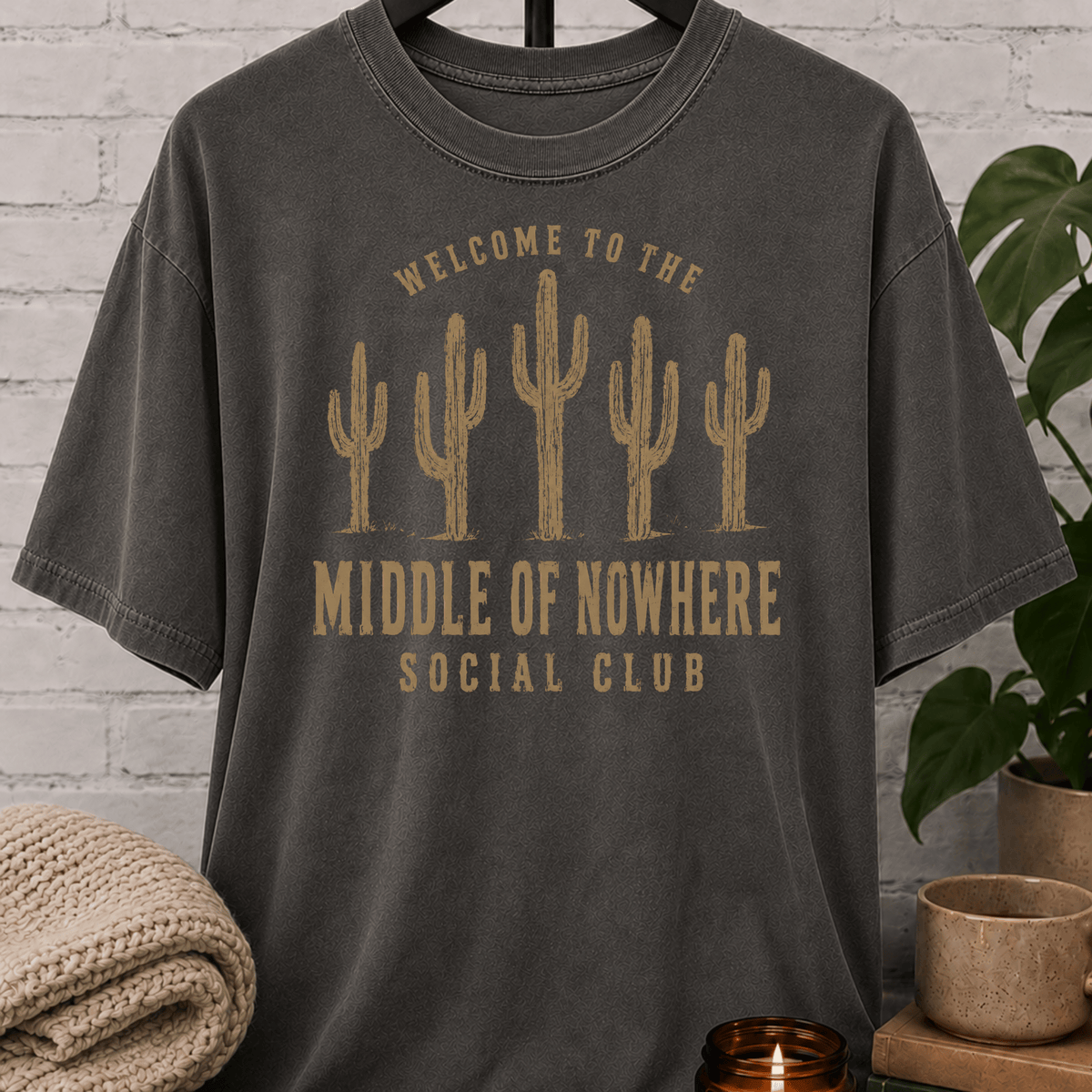 Western cactus graphic T-shirt featuring five desert cacti and the phrase “Welcome to the Middle of Nowhere Social Club,” a loner shirt for hermits, solitude lovers, and people who prefer fewer crowds.
