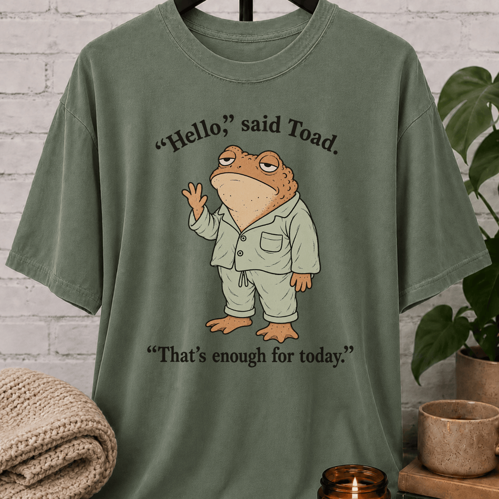 Social battery toad T-shirt featuring an unimpressed cartoon toad waving with the phrase “Hello, said Toad. That’s enough for today,” a socially drained graphic tee for awkward humor fans and people with limited social energy.