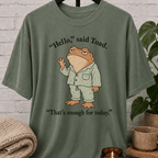 Social battery toad T-shirt featuring an unimpressed cartoon toad waving with the phrase “Hello, said Toad. That’s enough for today,” a socially drained graphic tee for awkward humor fans and people with limited social energy.