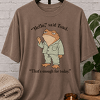 Social battery toad T-shirt featuring an unimpressed cartoon toad waving with the phrase “Hello, said Toad. That’s enough for today,” a socially drained graphic tee for awkward humor fans and people with limited social energy.