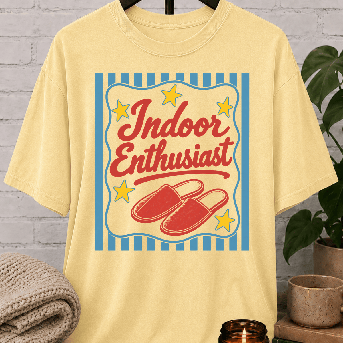 Indoor Enthusiast stay home T-shirt featuring cozy slippers, retro stars, and bold vintage artwork, an indoorsy graphic tee for people who prefer staying in and skipping plans.