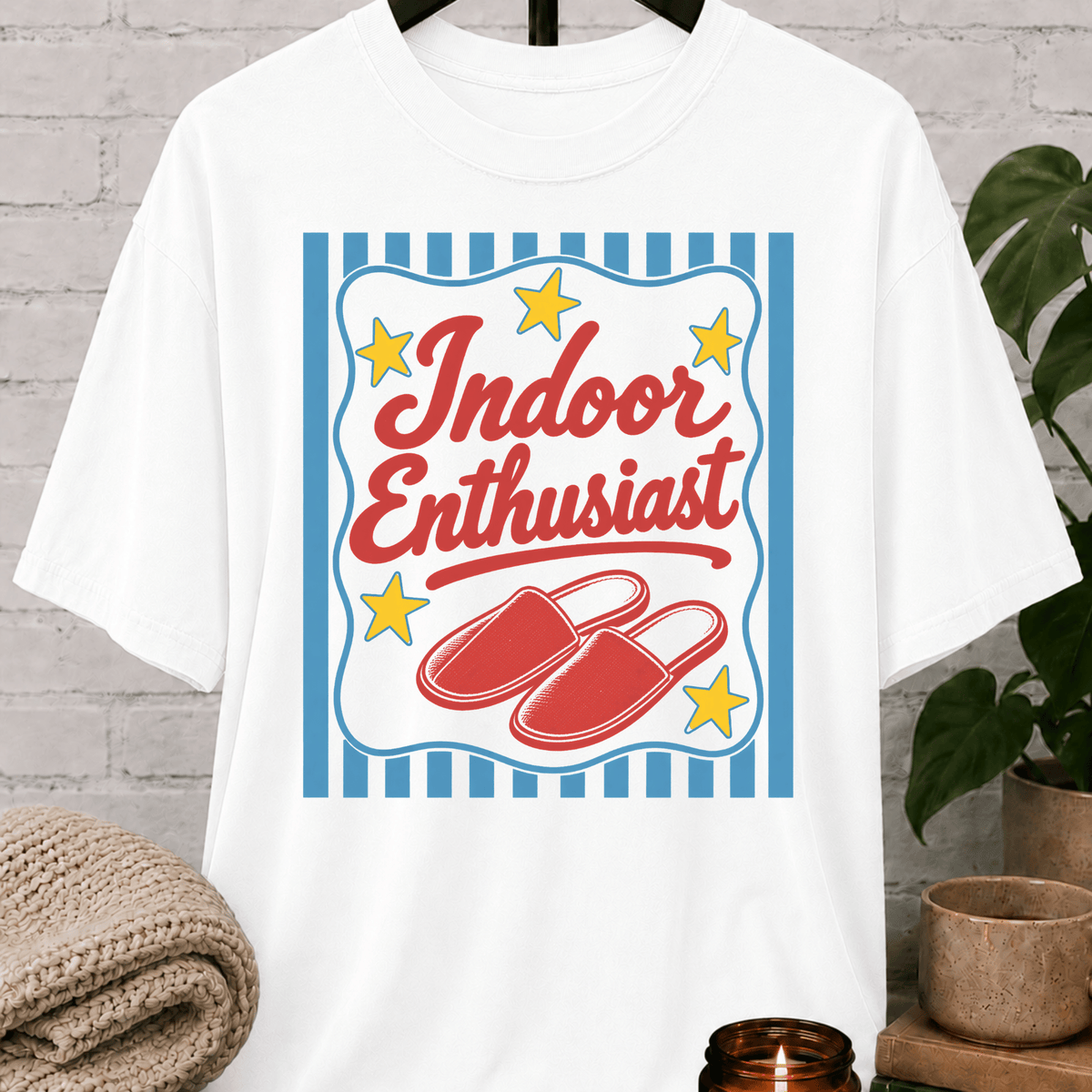 Indoor Enthusiast stay home T-shirt featuring cozy slippers, retro stars, and bold vintage artwork, an indoorsy graphic tee for people who prefer staying in and skipping plans.