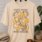 Socially unavailable banana T-shirt featuring vintage banana illustrations and the phrase “Slightly Bananas Mostly Unavailable,” a sarcastic graphic tee for loners, hermits, and people who prefer limited interaction.