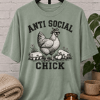 Antisocial chicken graphic T-shirt featuring a hen in sunglasses and a bandana with eggs and the phrase “Anti Social Chick,” a sarcastic farm animal shirt for socially selective humor fans.