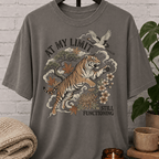 Overstimulated tiger graphic T-shirt featuring a leaping tiger with floral artwork, cranes, and the phrase “At My Limit Still Functioning,” a sarcastic graphic tee for overthinkers, overwhelmed people, and anxious humor fans.