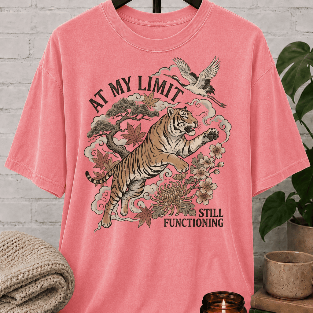 Overstimulated tiger graphic T-shirt featuring a leaping tiger with floral artwork, cranes, and the phrase “At My Limit Still Functioning,” a sarcastic graphic tee for overthinkers, overwhelmed people, and anxious humor fans.