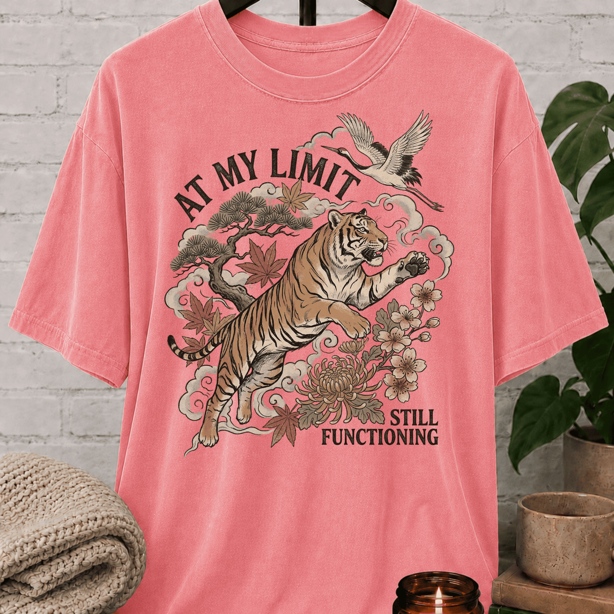 Overstimulated tiger graphic T-shirt featuring a leaping tiger with floral artwork, cranes, and the phrase “At My Limit Still Functioning,” a sarcastic graphic tee for overthinkers, overwhelmed people, and anxious humor fans.