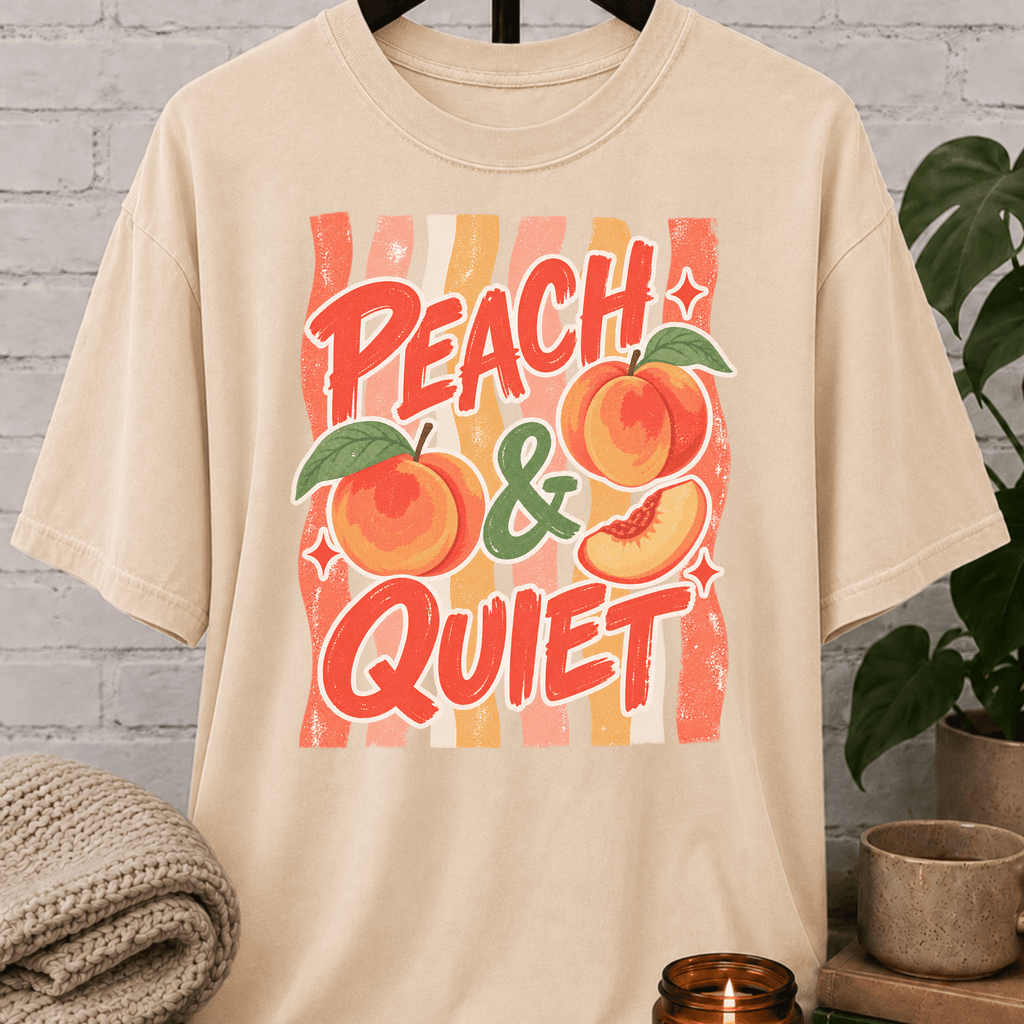Peach and Quiet graphic T-shirt featuring retro peach illustrations and bold lettering, a peace and quiet shirt for solitude lovers, quiet types, and fans of vintage fruit graphics.