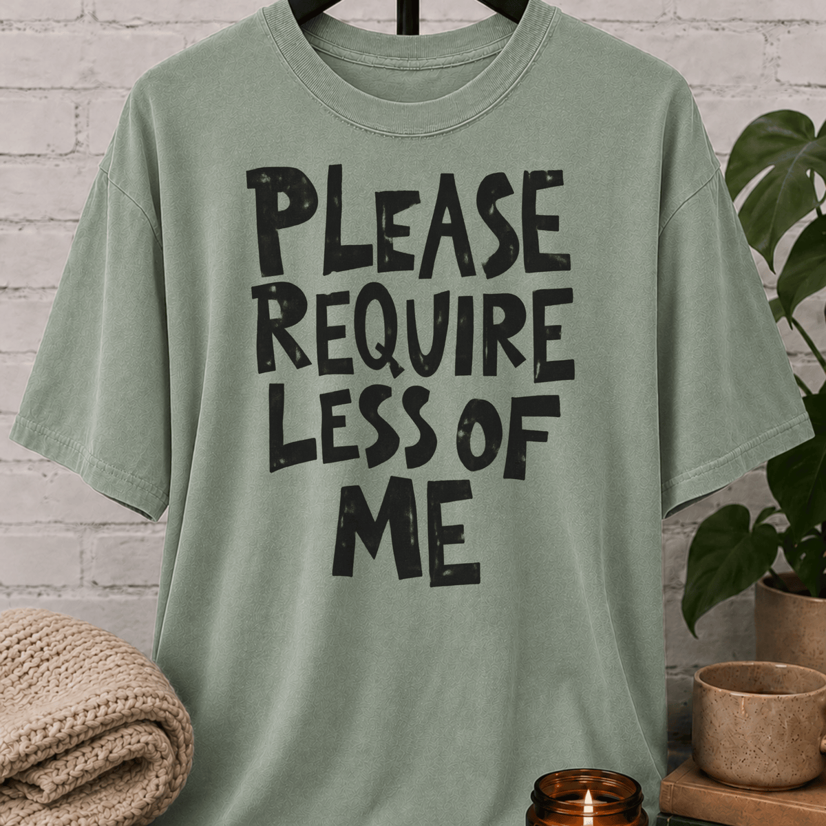 Overwhelmed humor graphic T-shirt featuring the bold phrase “Please Require Less of Me,” a sarcastic low social battery shirt for overthinkers, socially drained people, and anyone with limited bandwidth.