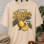 Sarcastic citrus graphic T-shirt featuring vintage citrus fruit, leafy branches, white blossoms, and the phrase “A Little Bitter,” a retro botanical shirt for socially selective people and sarcastic humor fans.