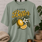 Sarcastic citrus graphic T-shirt featuring vintage citrus fruit, leafy branches, white blossoms, and the phrase “A Little Bitter,” a retro botanical shirt for socially selective people and sarcastic humor fans.