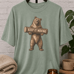 Antisocial bear graphic T-shirt featuring a standing brown bear holding a log with the phrase “Keep It Moving,” a sarcastic personal space shirt for loners, people avoiders, and fans of leave-me-alone humor.