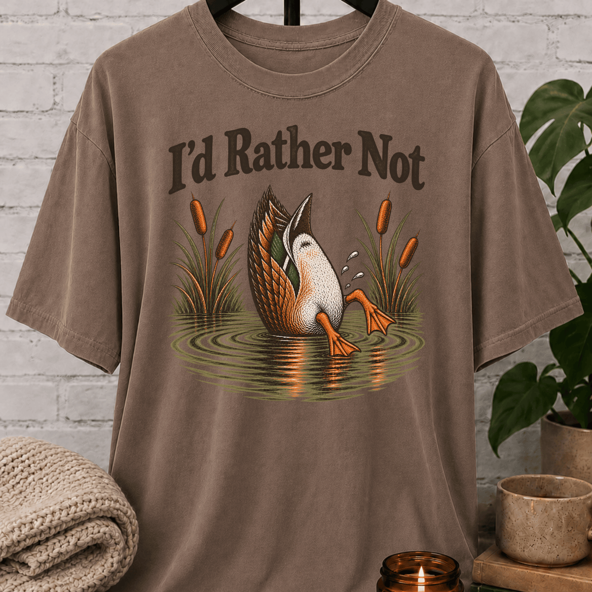 Socially selective duck graphic T-shirt featuring a duck diving into a pond with cattails and the phrase “I’d Rather Not,” a sarcastic people-avoidance shirt for loners, quiet types, and fans of staying out of unnecessary plans.
