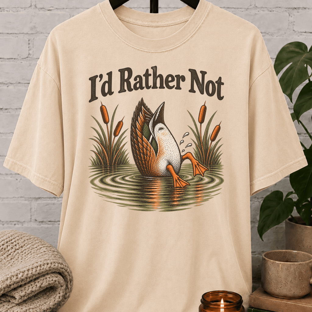 Socially selective duck graphic T-shirt featuring a duck diving into a pond with cattails and the phrase “I’d Rather Not,” a sarcastic people-avoidance shirt for loners, quiet types, and fans of staying out of unnecessary plans.
