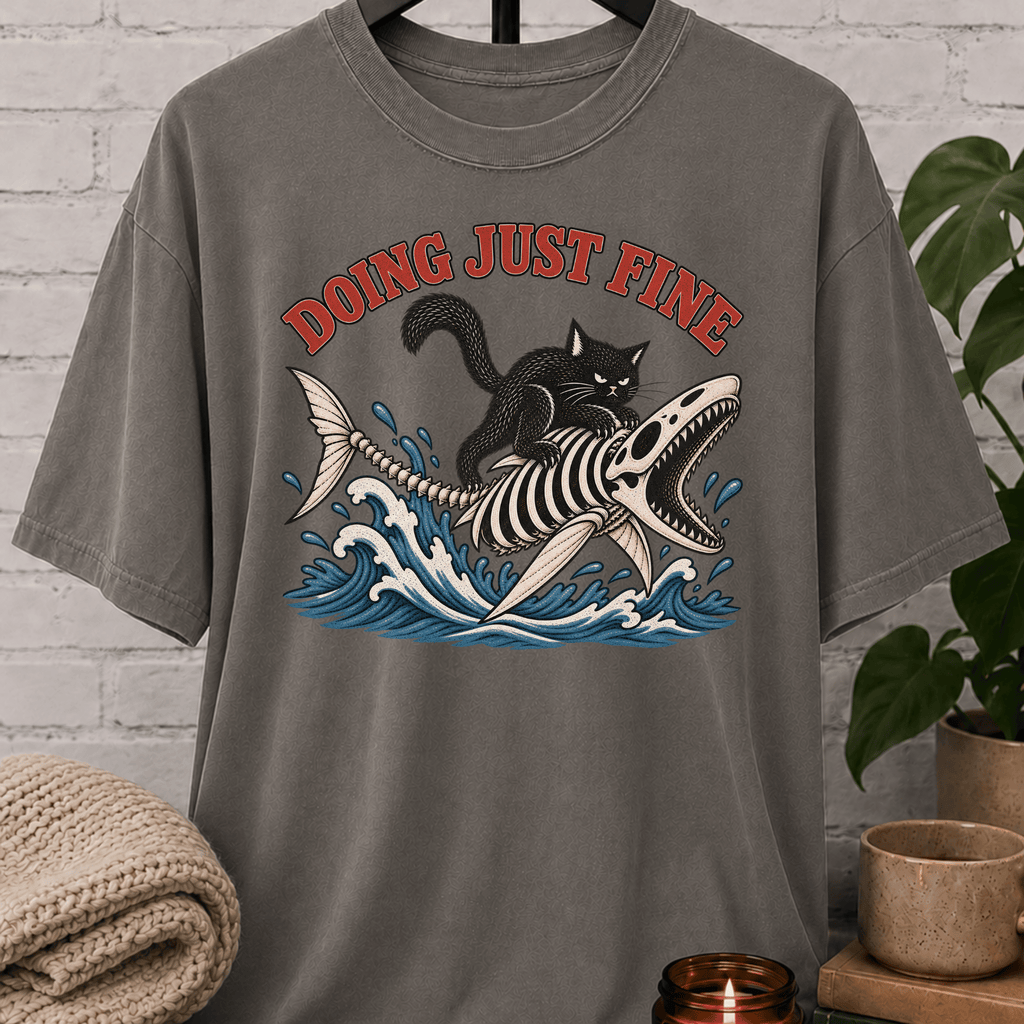 Overthinker black cat graphic T-shirt featuring a black cat riding a fish skeleton through ocean waves with the phrase “Doing Just Fine,” a sarcastic dark humor shirt for overwhelmed people and anxious humor fans.