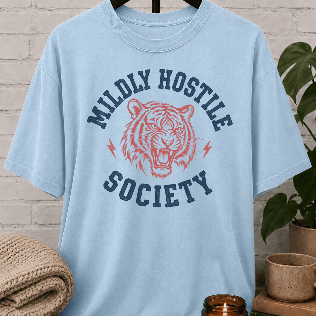 Socially selective tiger graphic T-shirt featuring a snarling tiger, lightning bolt accents, and the phrase “Mildly Hostile Society,” a sarcastic antisocial shirt for people who prefer fewer conversations and more personal space.