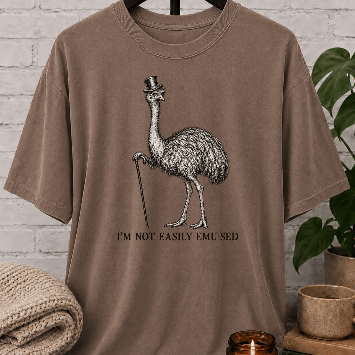 Sarcastic emu graphic T-shirt featuring a vintage emu wearing a top hat and holding a cane with the phrase “I’m Not Easily Emu-sed,” a quirky animal humor shirt for socially selective and hard-to-impress people.