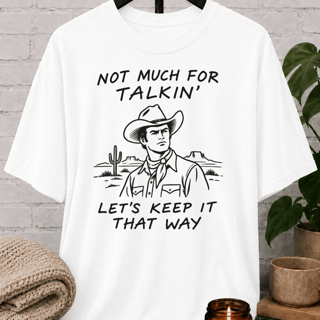 Western cowboy graphic T-shirt featuring a vintage cowboy, cactus desert scene, and the phrase “Not Much for Talkin’ Let’s Keep It That Way,” a sarcastic small talk shirt for socially selective people and conversation avoiders.