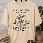 Western cowboy graphic T-shirt featuring a vintage cowboy, cactus desert scene, and the phrase “Not Much for Talkin’ Let’s Keep It That Way,” a sarcastic small talk shirt for socially selective people and conversation avoiders.