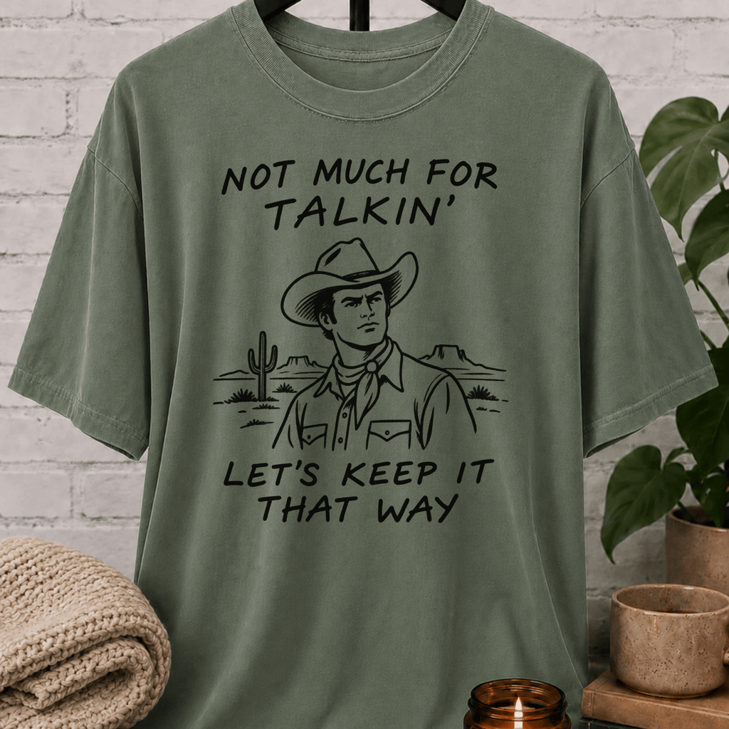 Western cowboy graphic T-shirt featuring a vintage cowboy, cactus desert scene, and the phrase “Not Much for Talkin’ Let’s Keep It That Way,” a sarcastic small talk shirt for socially selective people and conversation avoiders.