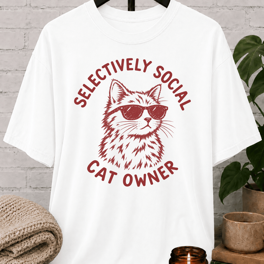 Cat lover graphic T-shirt featuring a cat wearing sunglasses with the phrase “Selectively Social Cat Owner,” a sarcastic cat shirt for socially selective people, cat owners, and feline humor fans.
