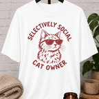 Cat lover graphic T-shirt featuring a cat wearing sunglasses with the phrase “Selectively Social Cat Owner,” a sarcastic cat shirt for socially selective people, cat owners, and feline humor fans.