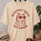 Cat lover graphic T-shirt featuring a cat wearing sunglasses with the phrase “Selectively Social Cat Owner,” a sarcastic cat shirt for socially selective people, cat owners, and feline humor fans.