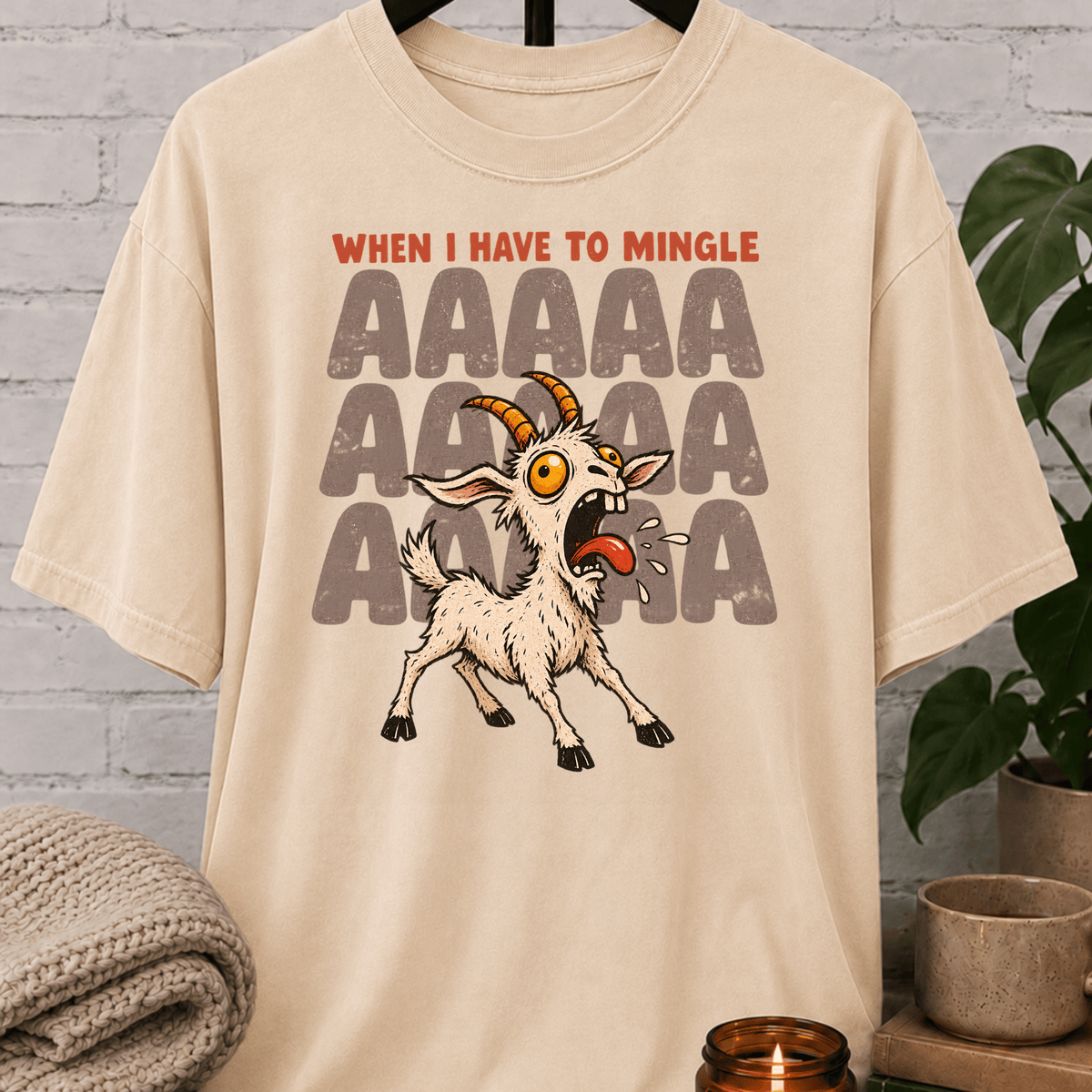 Socially awkward goat graphic T-shirt featuring a panicked screaming goat with the phrase “When I Have to Mingle,” a humorous social anxiety style shirt for reluctant minglers, awkward people, and crowd-avoidance humor fans.