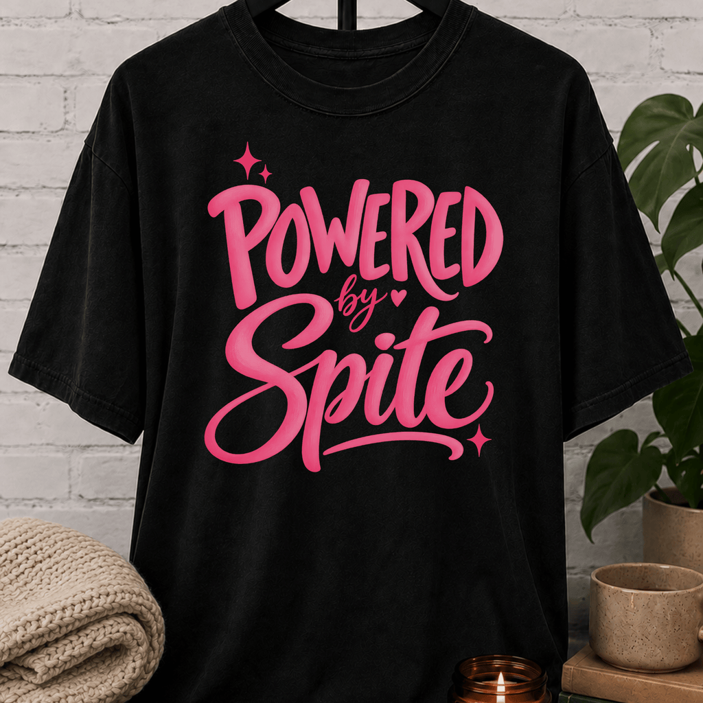 Powered by Spite graphic T-shirt featuring bold lettering and sparkle accents, a sarcastic petty humor shirt for stubborn personalities, spiteful humor fans, and people fueled by determination.