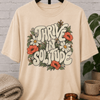 Solitude floral graphic T-shirt featuring retro daisies, poppies, leafy botanical artwork, and the phrase “Thrive in Solitude,” a loner shirt for people who enjoy alone time, quiet living, and their own company.